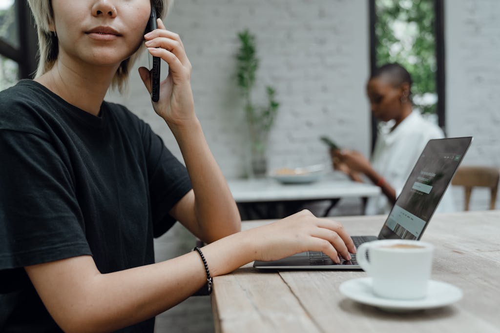 Person in casual wear making phone call in cafe